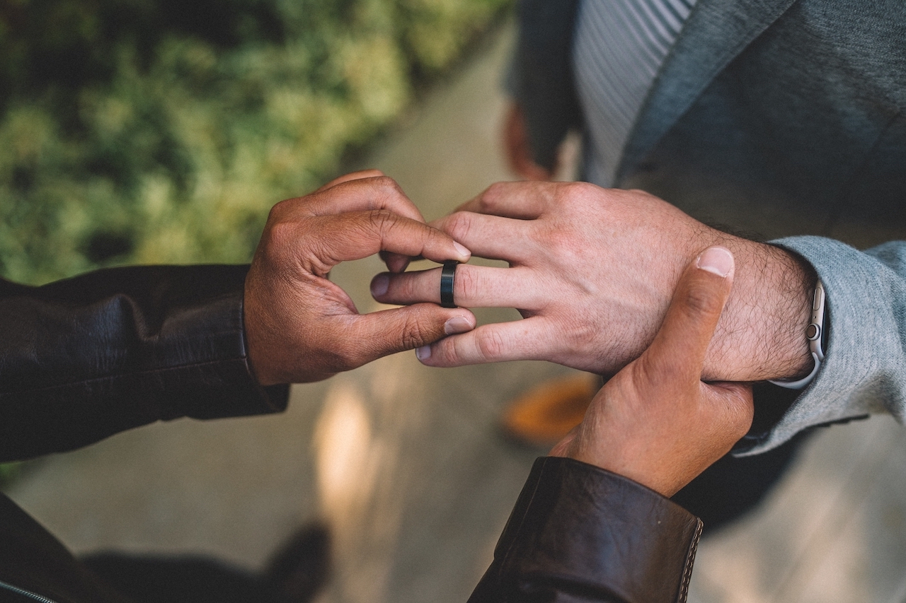 man taking off black wedding ring man taking off black wedding ring