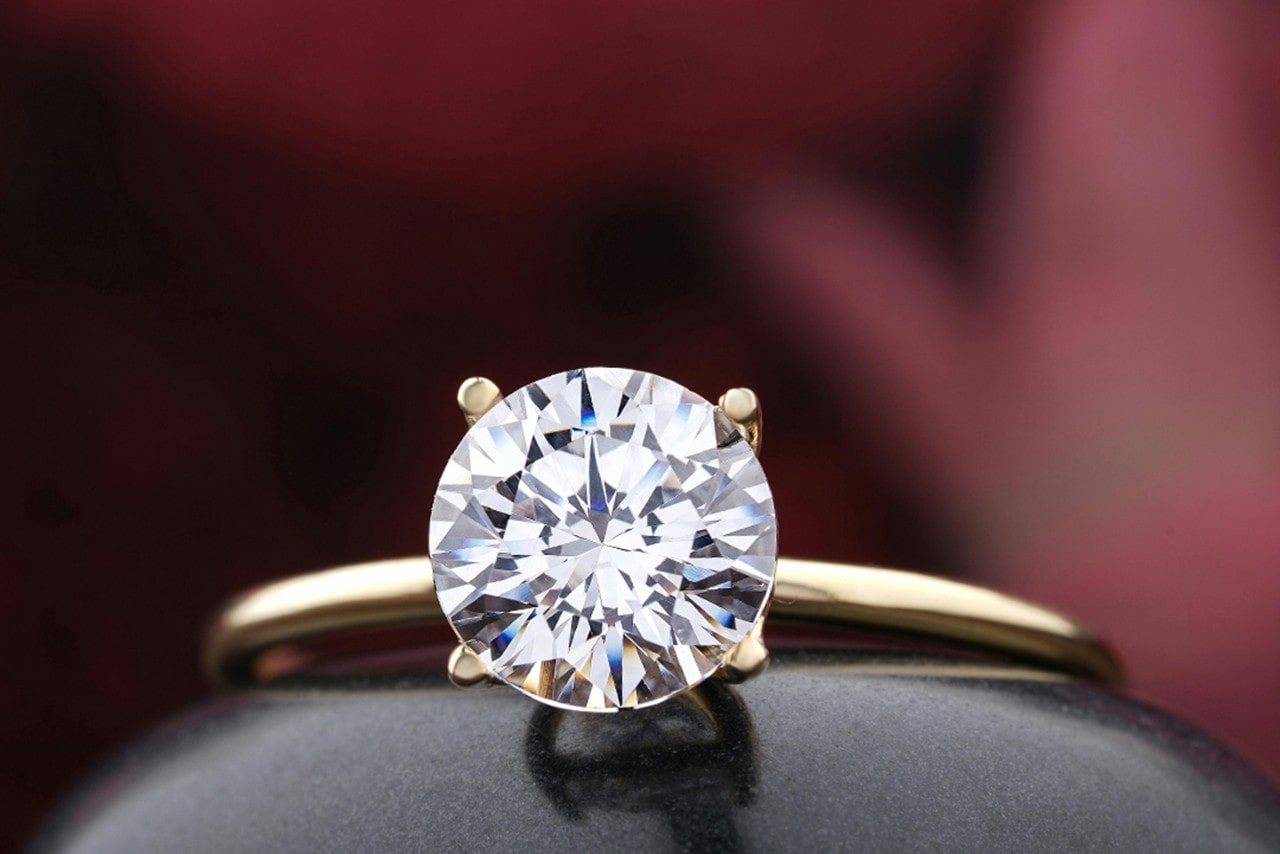 A solitaire yellow gold ring